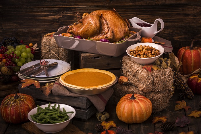 Roasted Thanksgiving Turkey with side dishes and autumn decoration